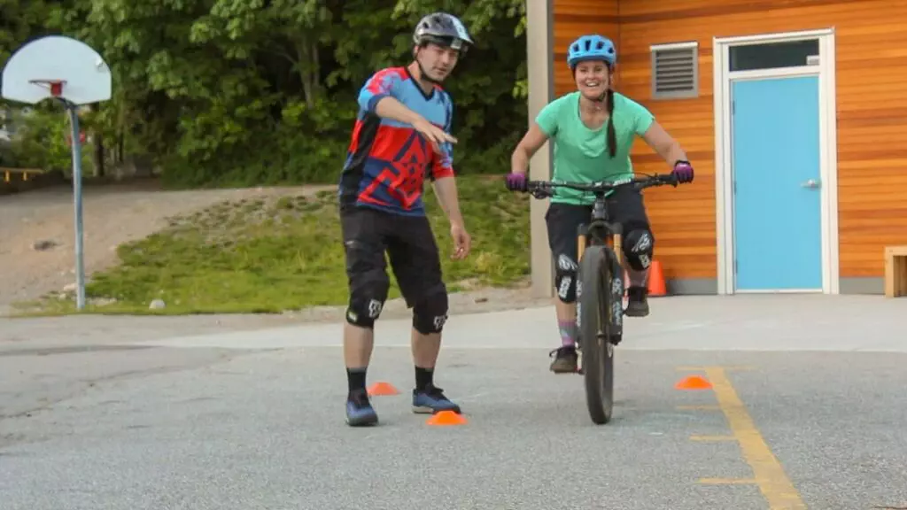 Two people enjoying Squamish Mountain Biking in a parking lot.