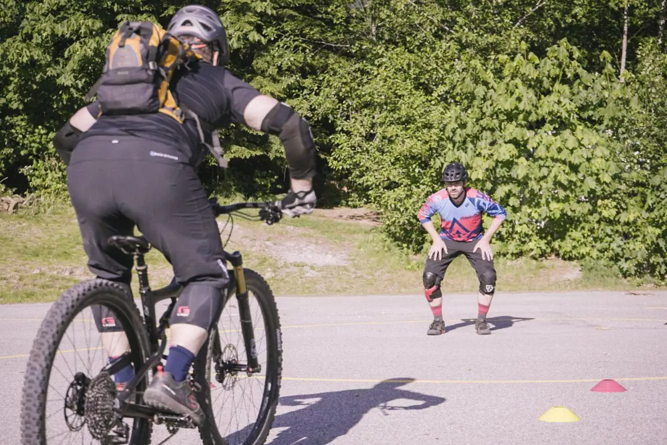 A group of people riding mountain bikes in a parking lot, fueled by their adventurous spirit.