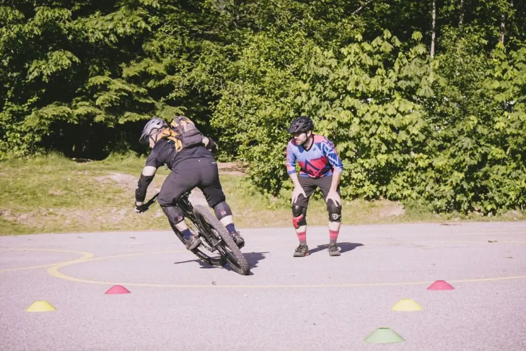 Two people enjoying an adventurous bike ride within a circle of cones.