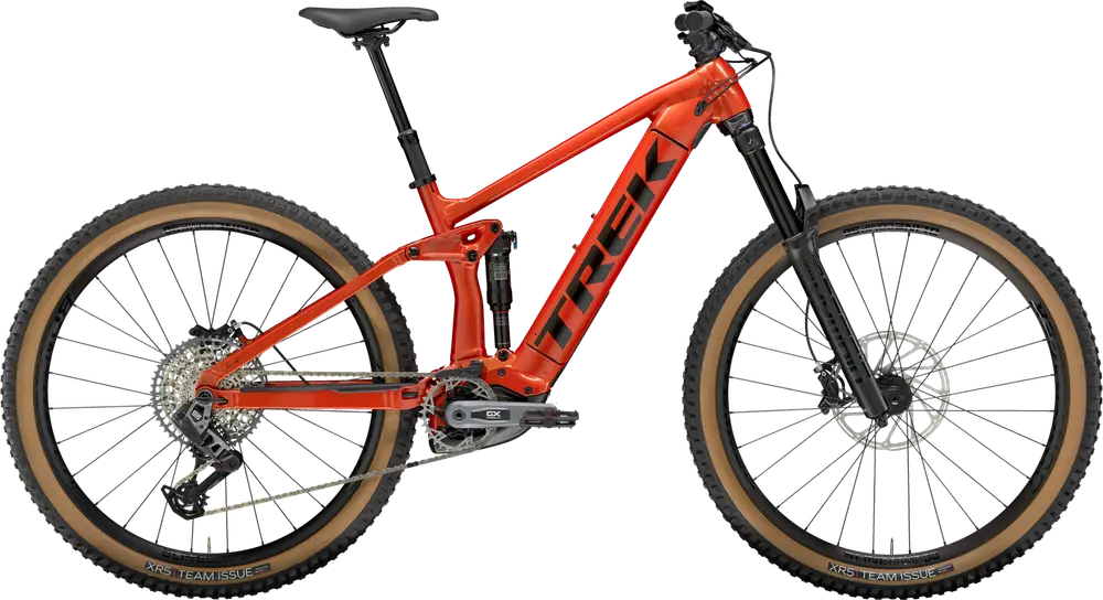 A red mountain bike with a full suspension frame, disc brakes, wide tires, and 