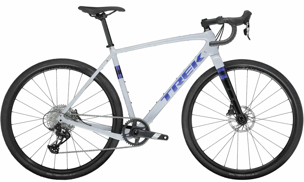 A white Trek gravel bike with drop handlebars, disc brakes, knobby tires, and a rear derailleur, shown from a right side profile view.