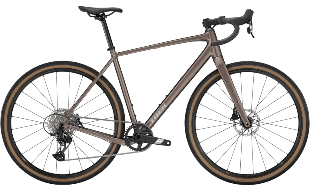 RideHub 22 A brown gravel bike with drop handlebars, disc brakes, and tan wall tires is shown in a side profile on a white background.